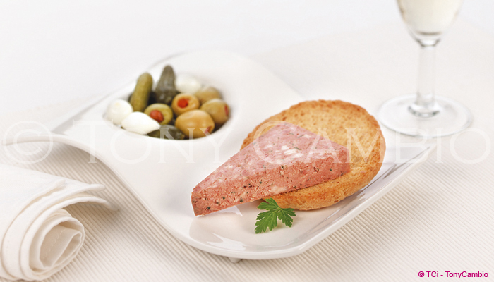 Pate on toasted white bread with olives and pickled onions
